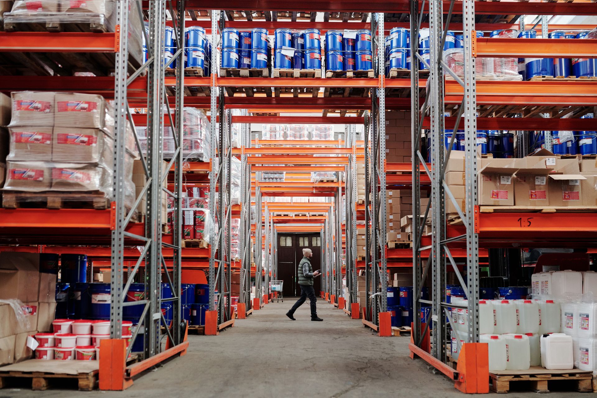 Warehouse shelves and worker on the background