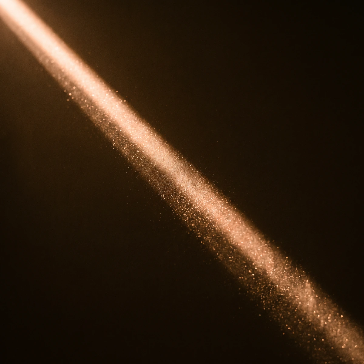 A single beam of warm light cutting through darkness, filled with glowing suspended particles.