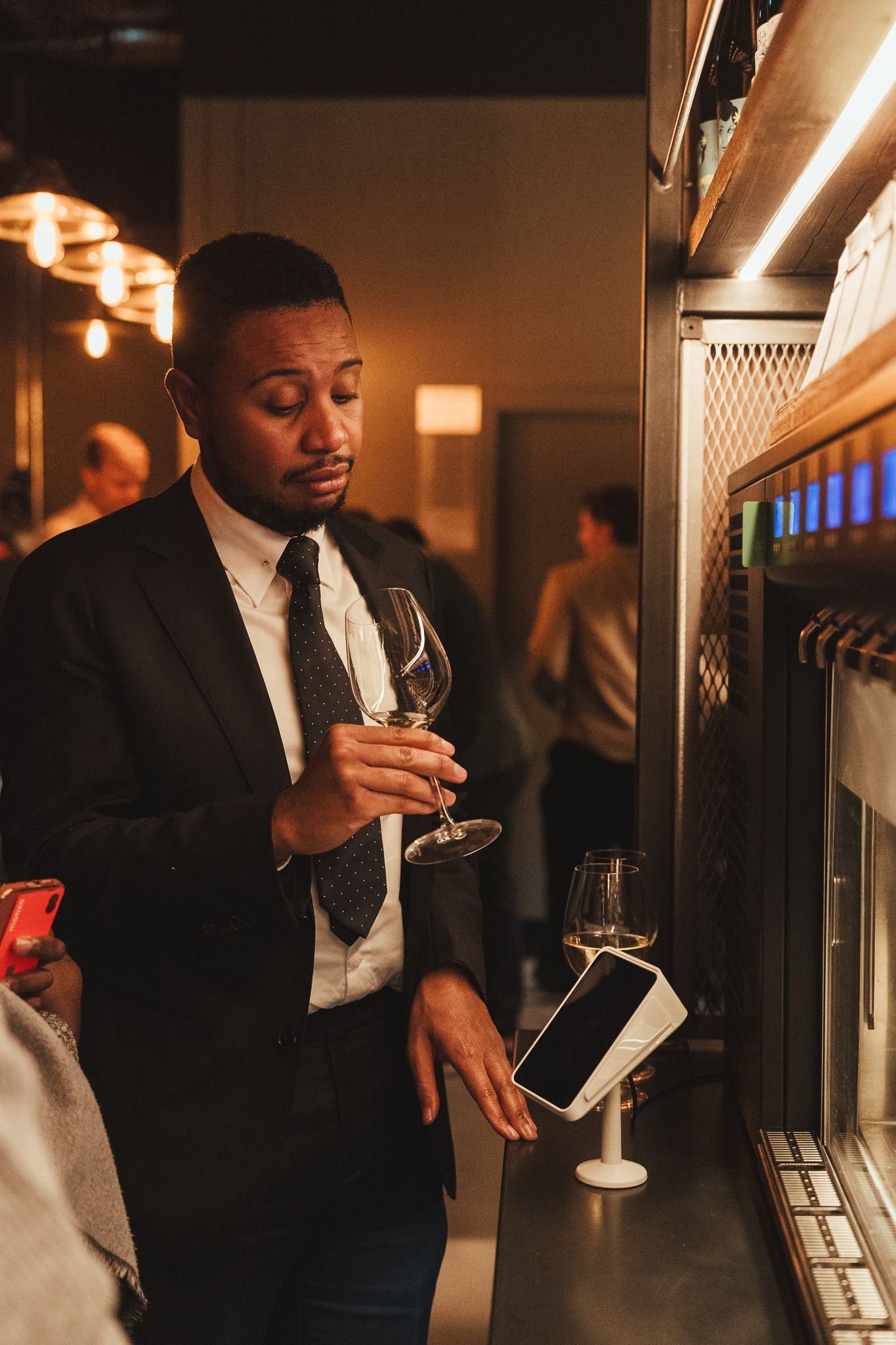 Guests sharing food and wine at the bar