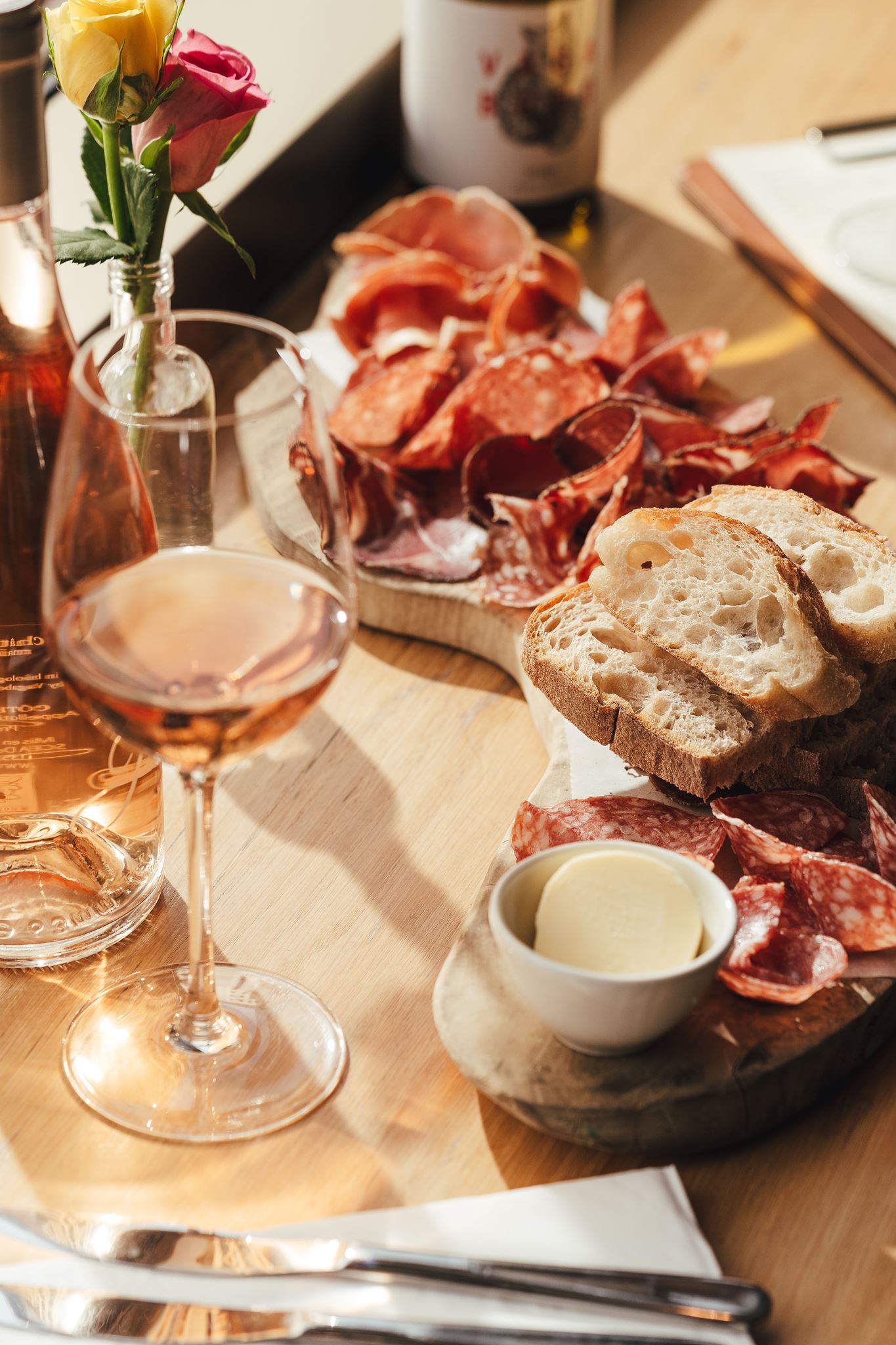 Guests sharing food and wine at the bar