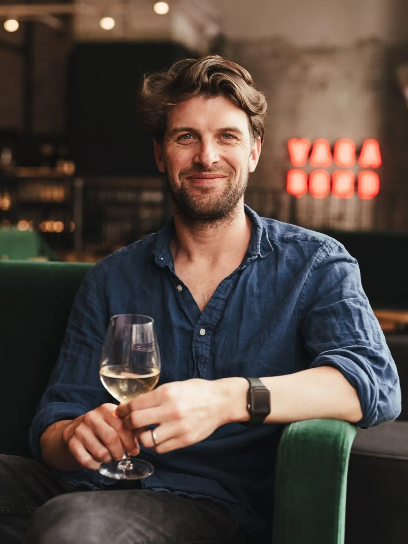 Jason Stevens, Vagabond Wine Academy educator, holding a glass of white wine