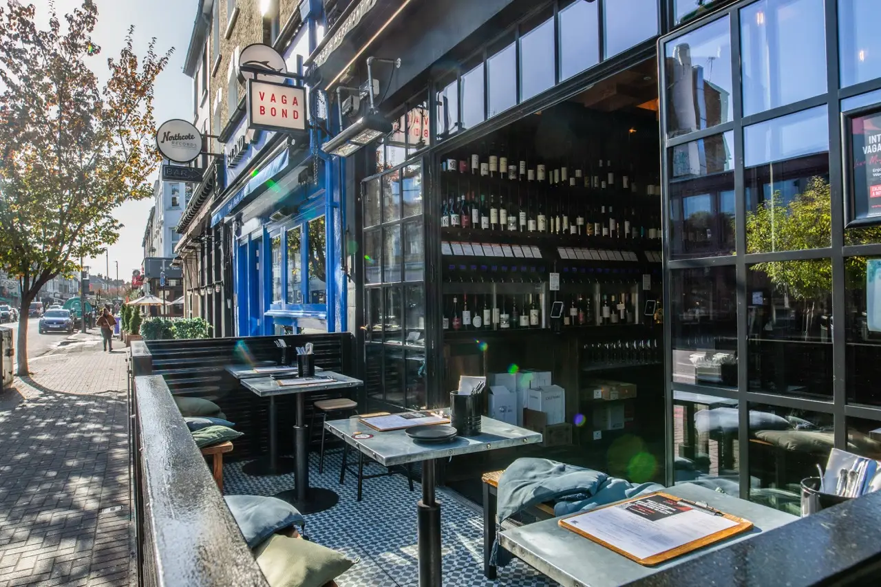 Pavement tables outside Vagabond Northcote Road in Battersea on a sunny day