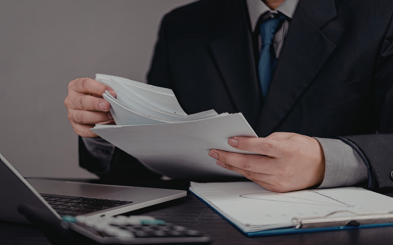 Insurance professional reviewing paper documents, representing manual document processing in insurance operations