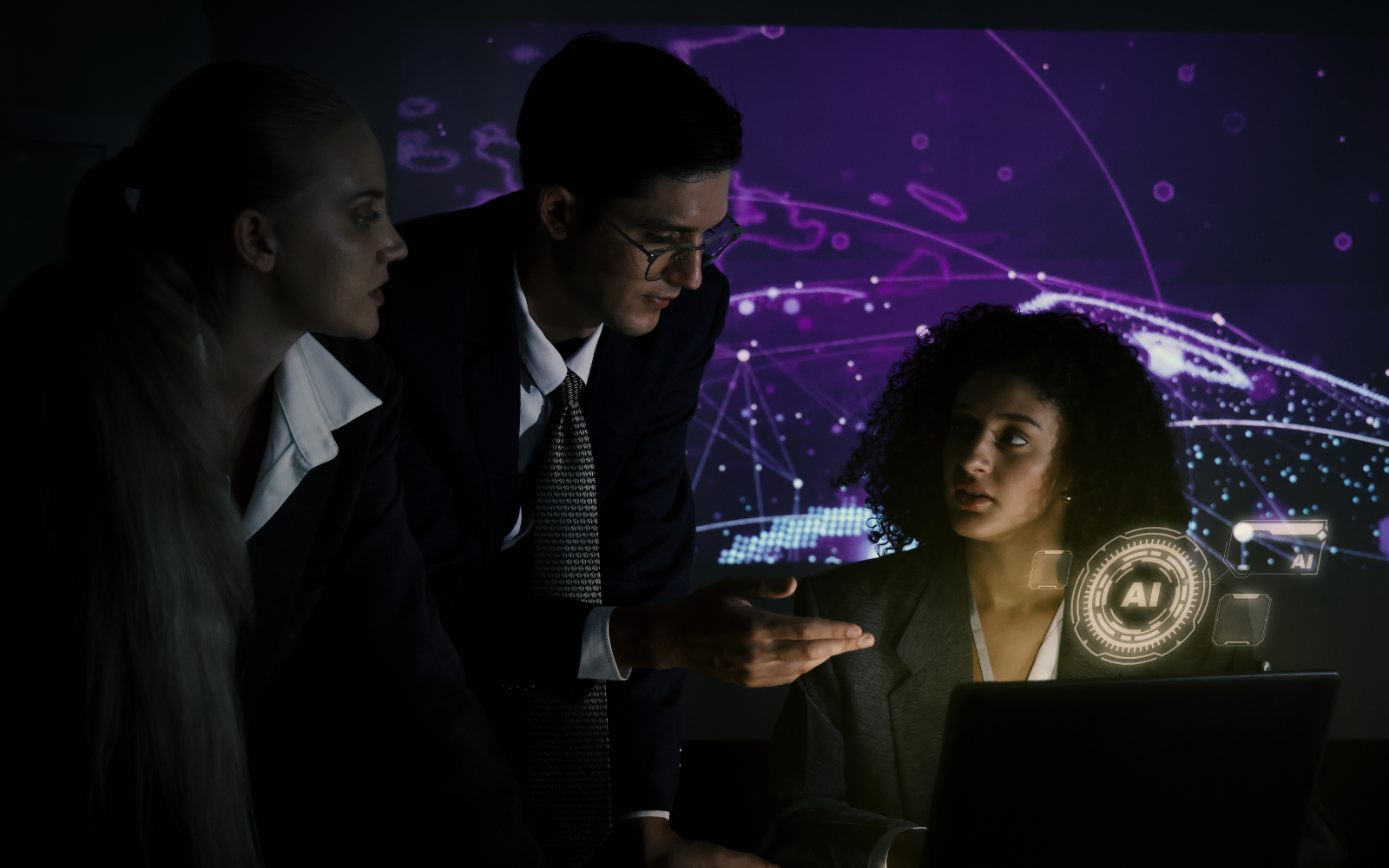 Business team discussing work around a laptop while using AI tools