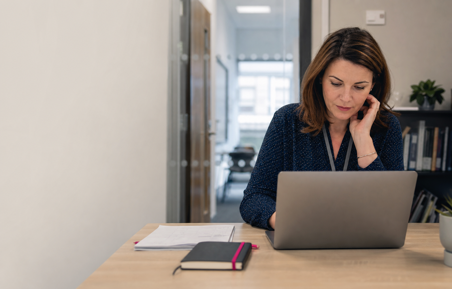 A SENCO reviewing learner records on a laptop.