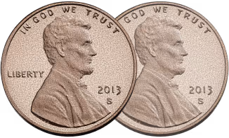 Two 2013 US Lincoln pennies side by side showing Lincoln's profile with IN GOD WE TRUST text.