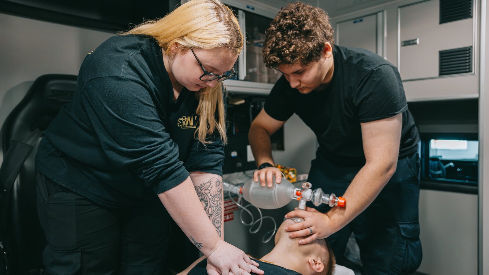 Northwest Rescue paramedic demonstrating proper hands-only CPR chest compressions during a bystander training session.