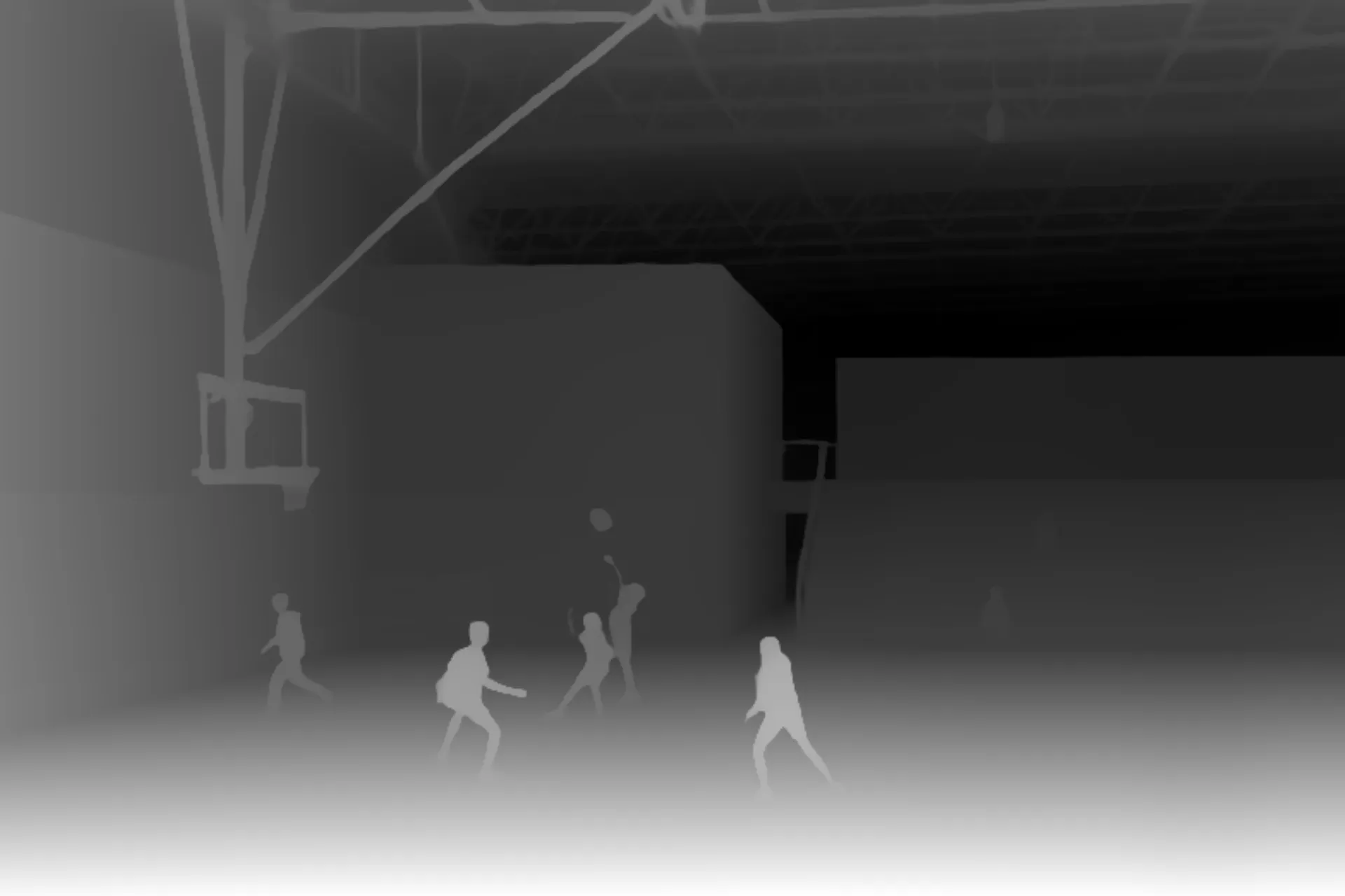 Silhouettes of people playing basketball indoors under a hoop in a large gym or sports hall.