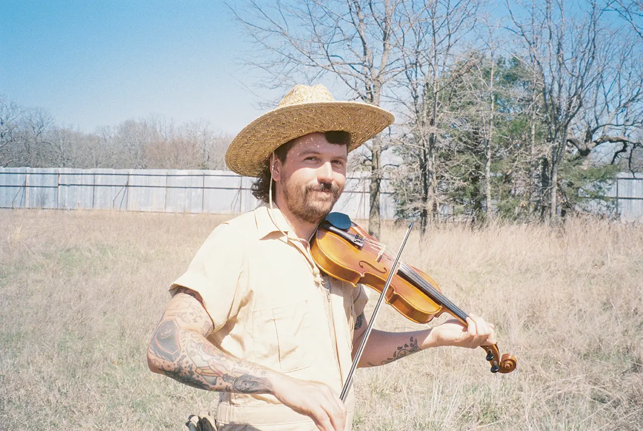 Nick Shoulders, holding a violin.