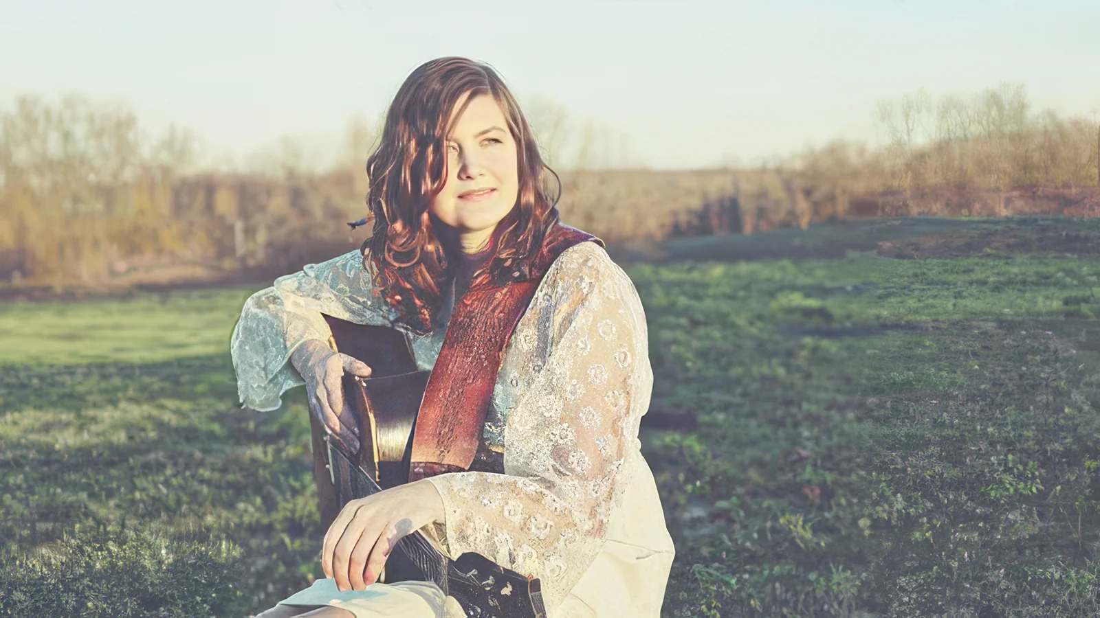 Portrait of Arkansas songwriter Cindy Woolf with guitar