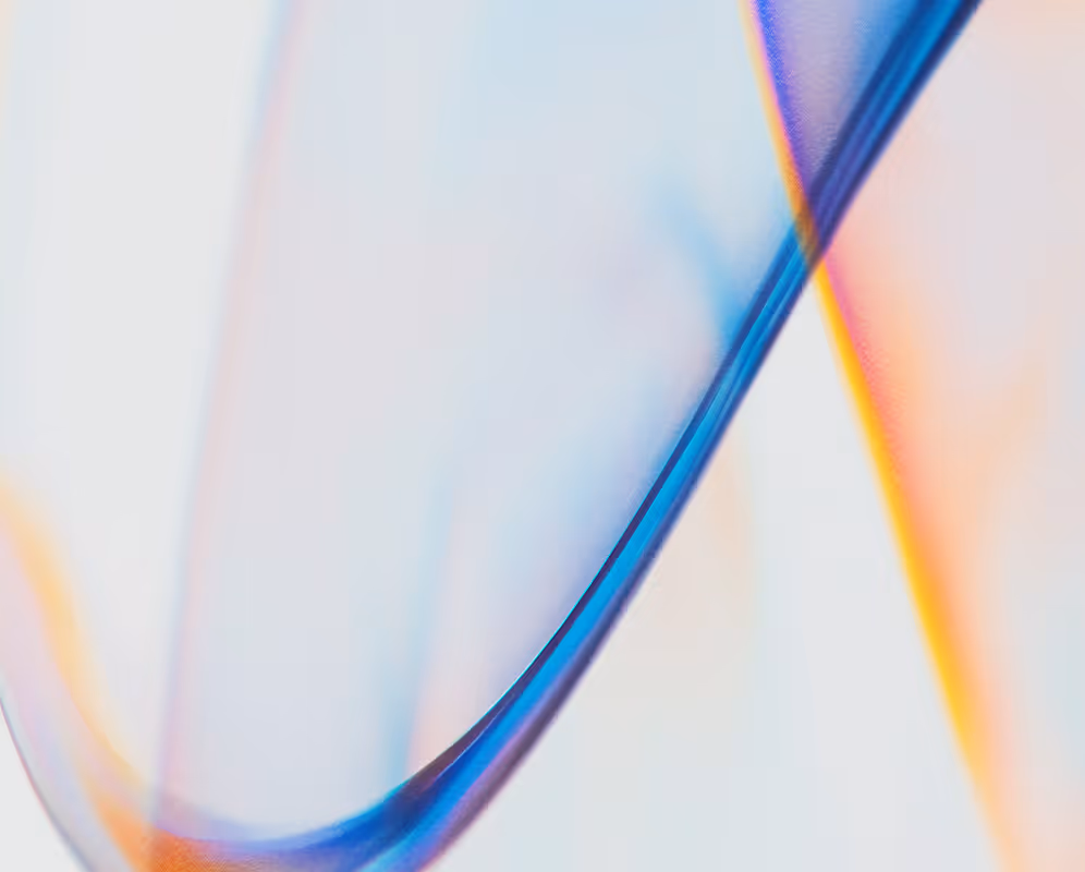 Abstract close-up of smooth, flowing translucent blue and orange shapes on a light background.