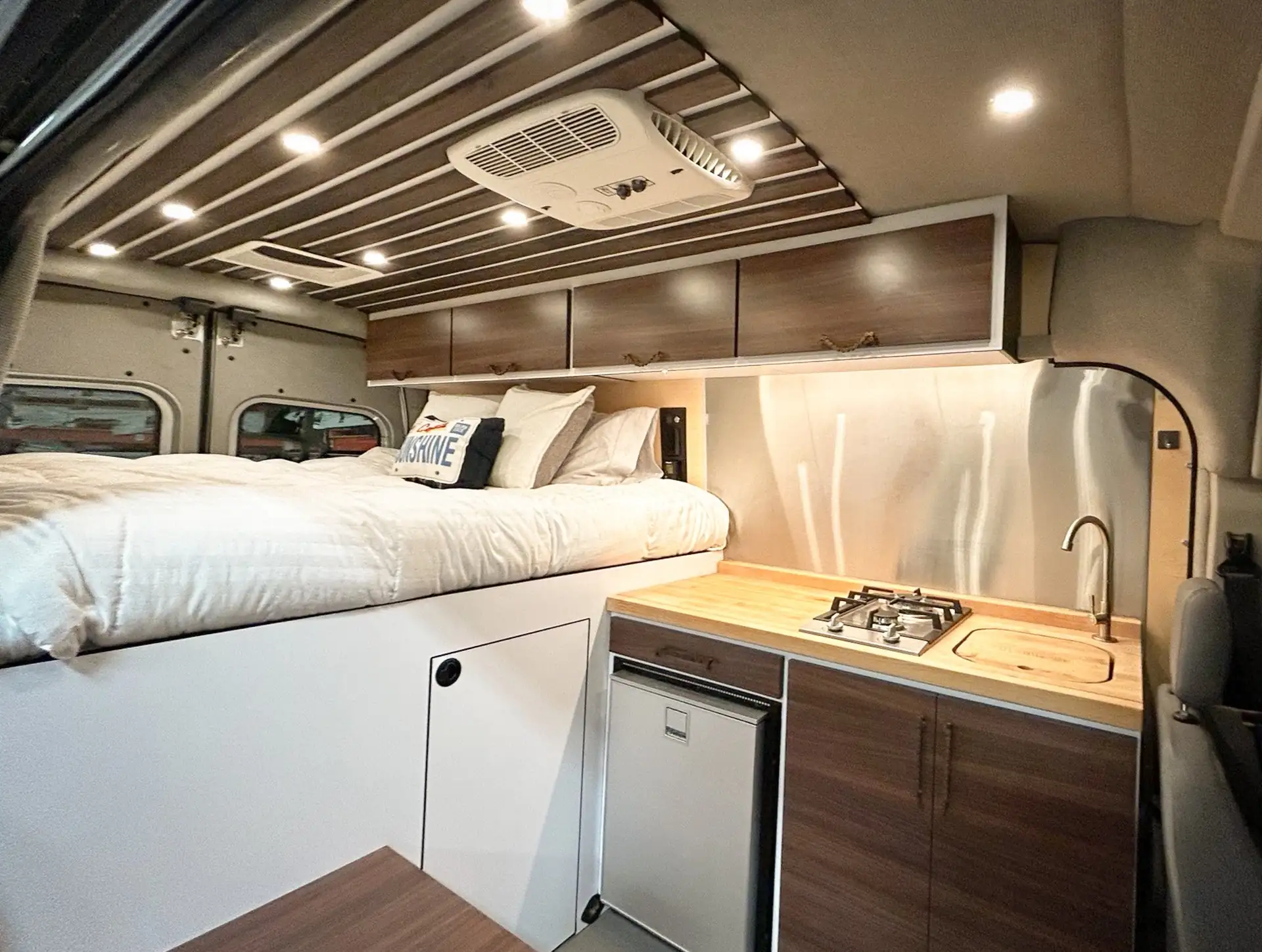 Custom van exterior with deployed awning at sunset