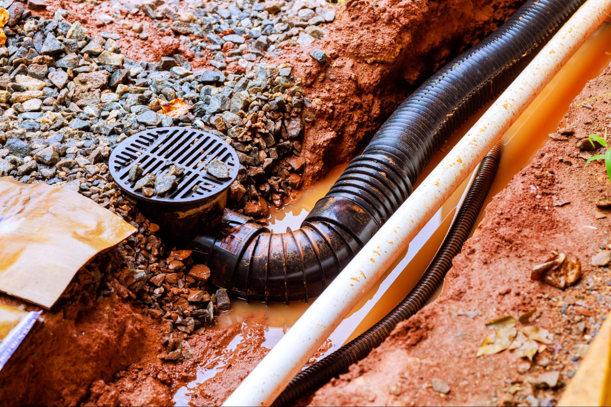 A catch basin collects water at a specific location rather than along a long line