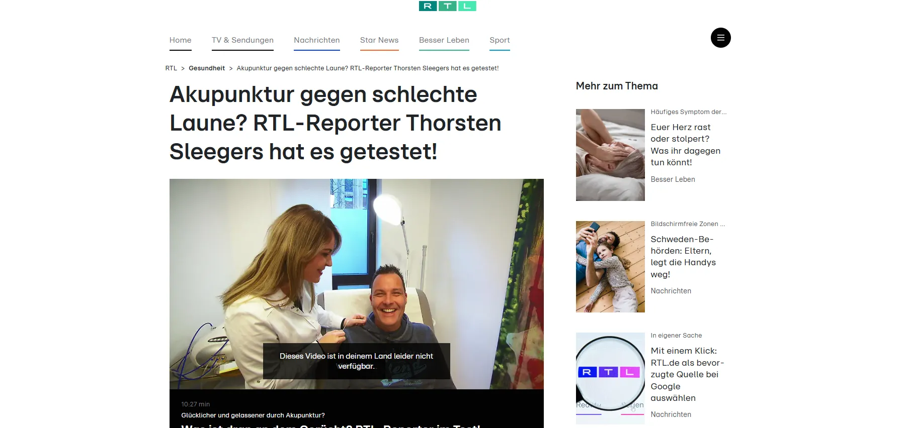 Woman performing acupuncture on a smiling man in a medical setting with equipment nearby.