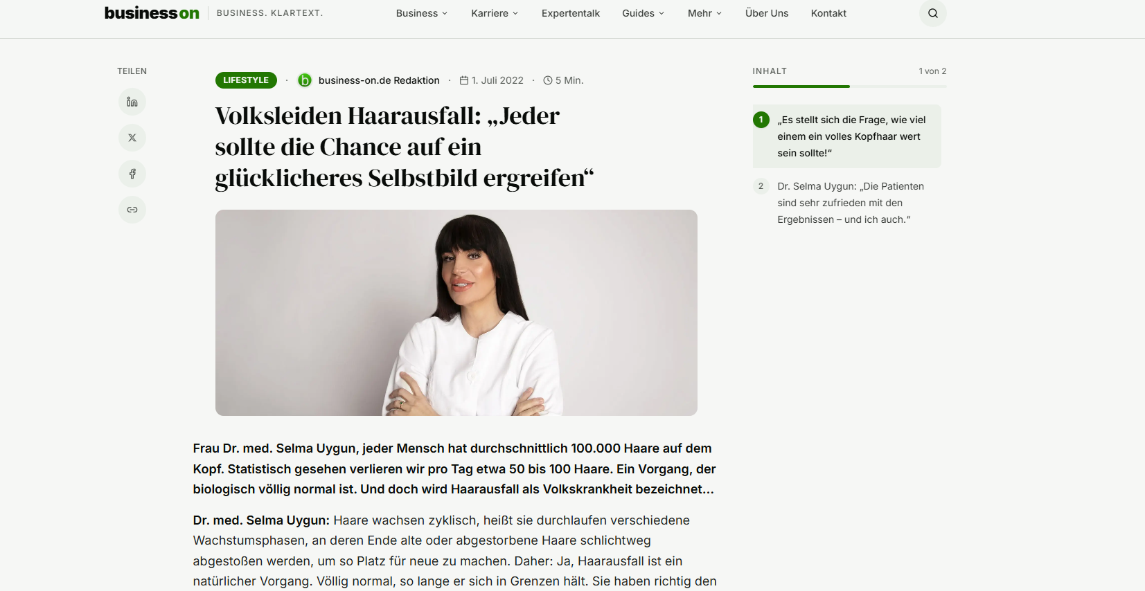 Woman with dark hair wearing white shirt smiling at camera with folded arms on business website.