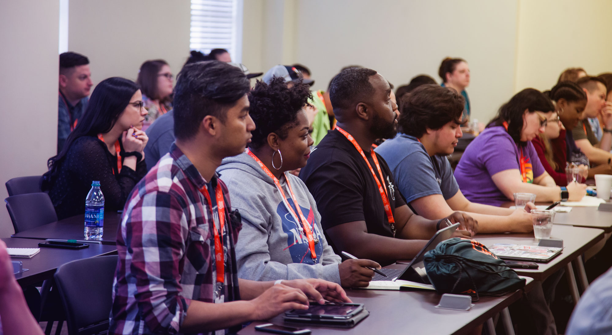 Diverse group of attentive adults seated in a classroom setting