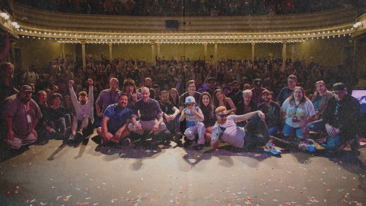 Large group of people in a theater posing for a photo