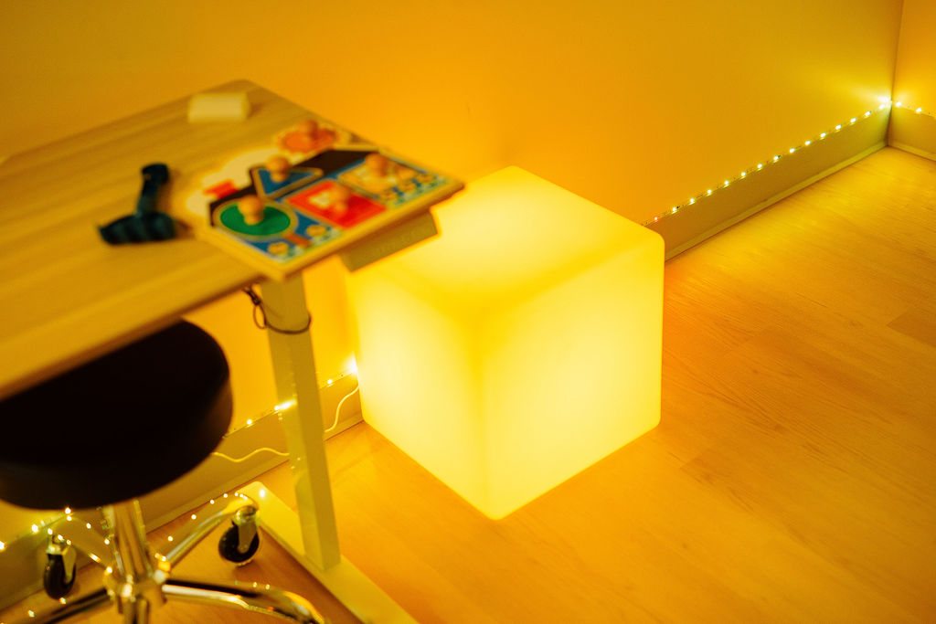 Calm sensory room at Oaklin Lane with warm lighting and a glowing light cube