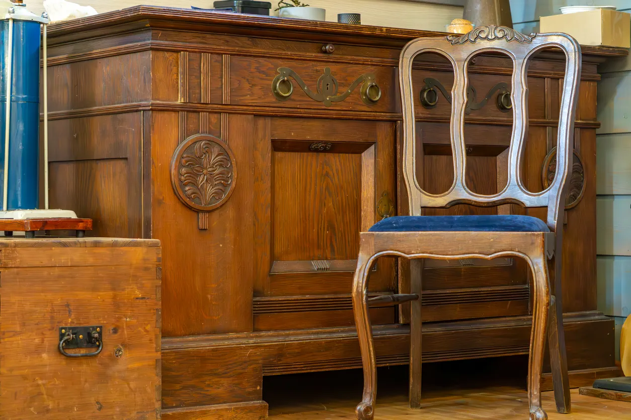 Antique wood furniture and chair awaiting contents restoration after fire or water damage in Goldsboro, NC