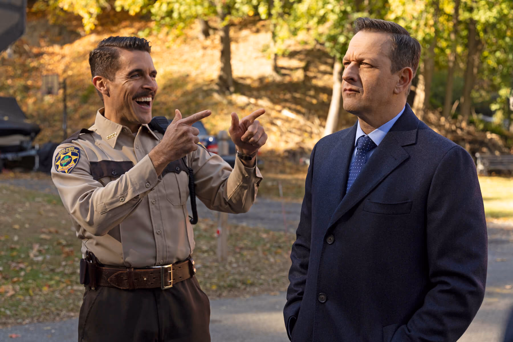 Sheriff's deputy laughing with a man in a suit