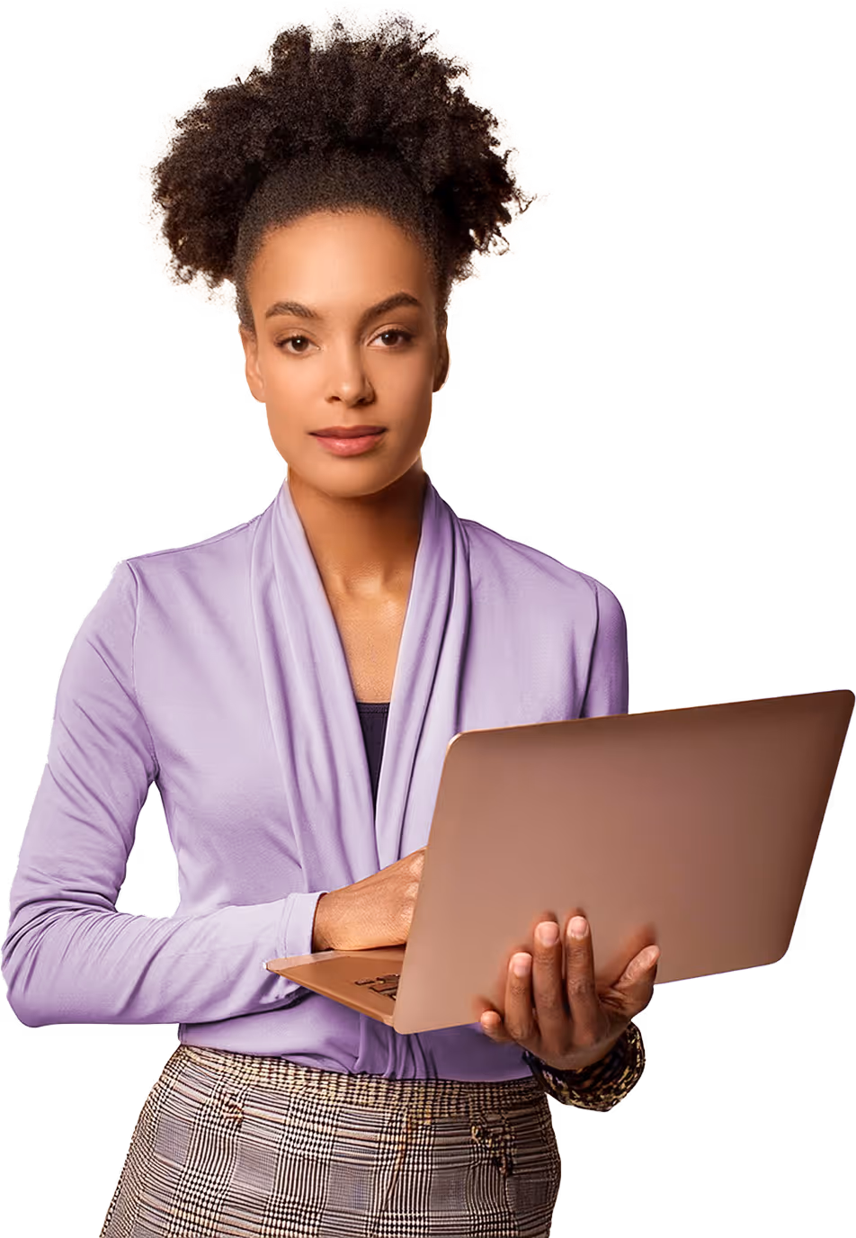 Young woman with curly hair holding an open laptop, wearing a lavender cardigan and plaid pants.