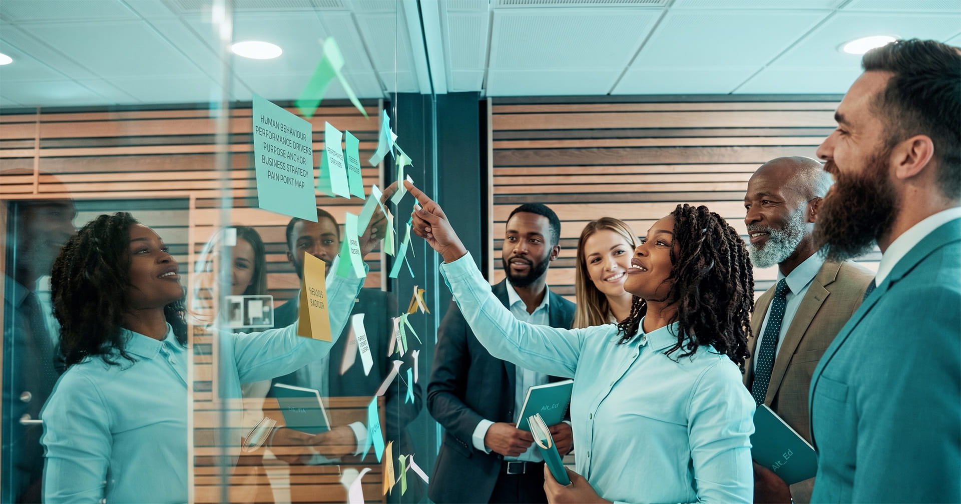 A group of team members brainstorming some ideas in a boardroom