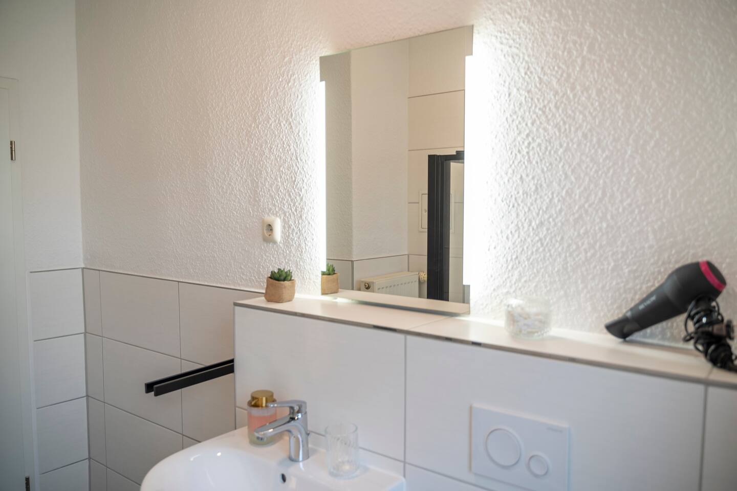 Bathroom with large mirror