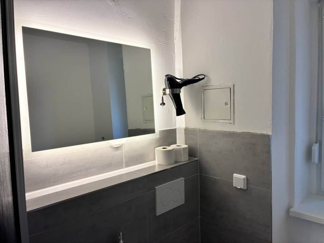 Bright, large mirror with hairdryer