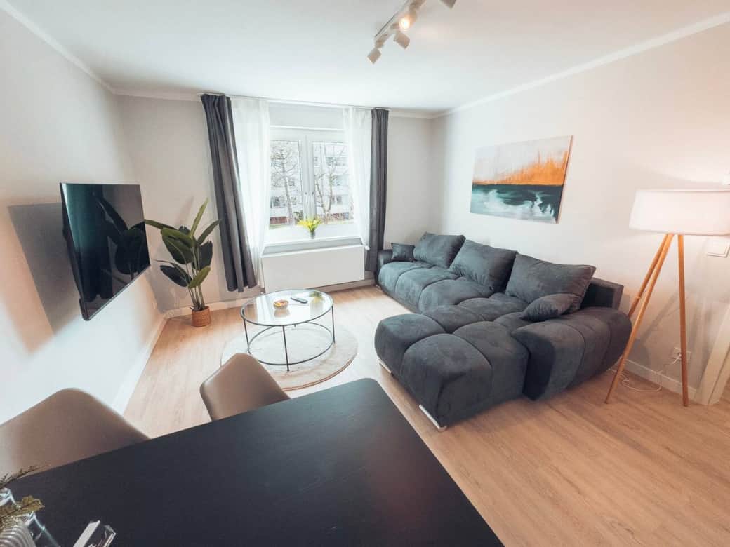 Bright living room with sofa bed & TV