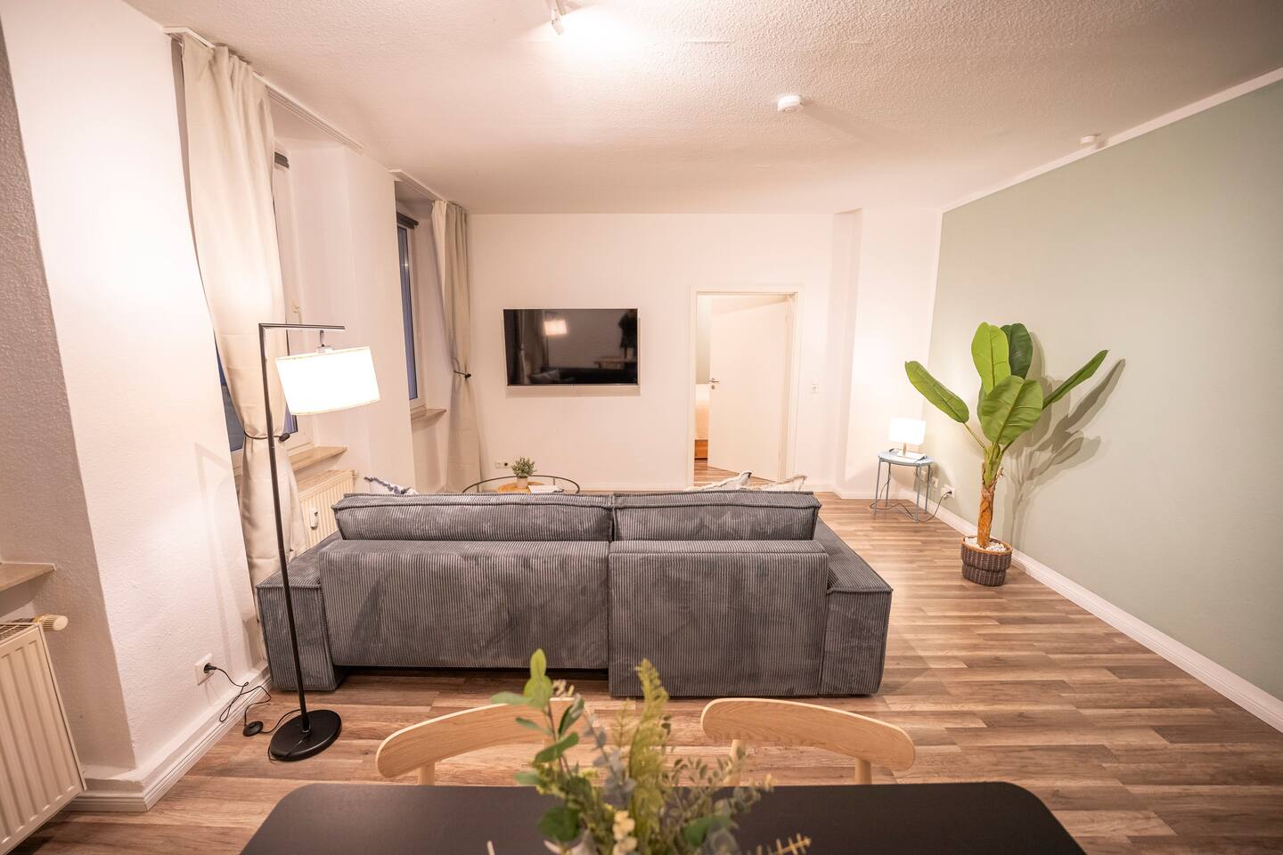Spacious living room with sofa & Smart TV
