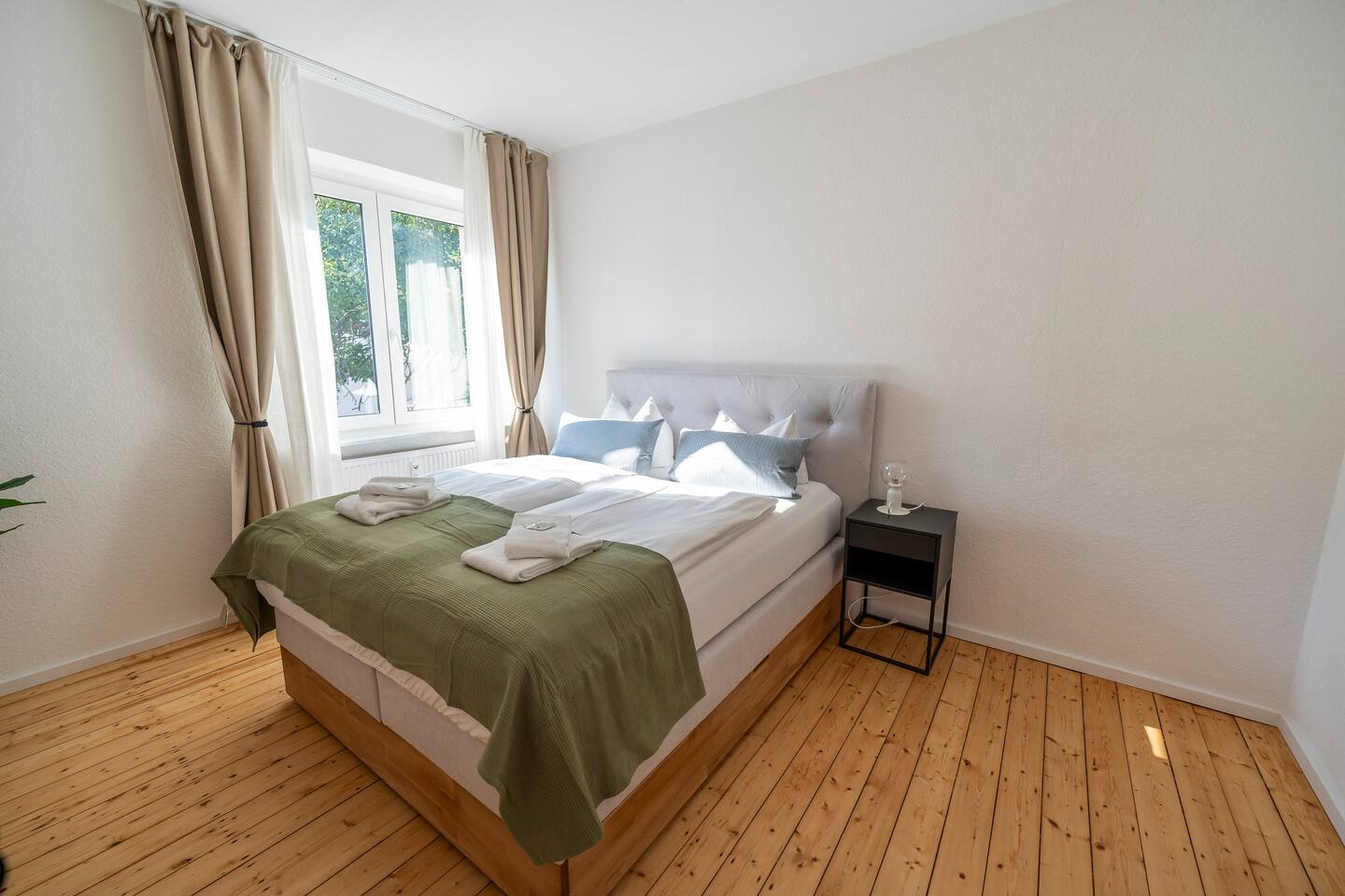Bright bedroom with a king-size double bed