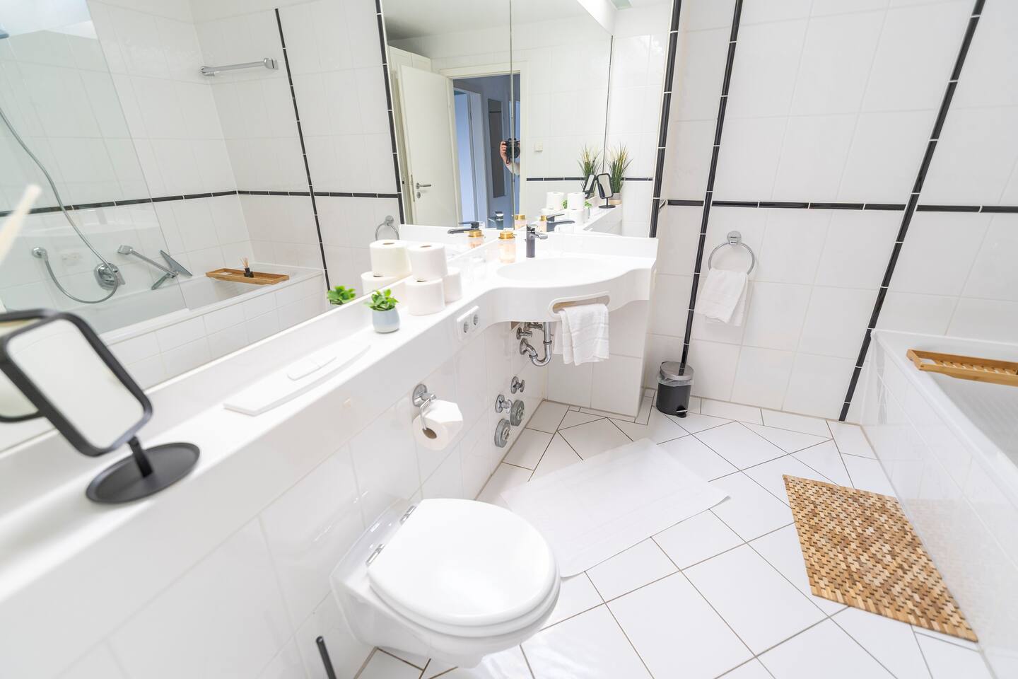 Bathroom with large mirror and bathtub