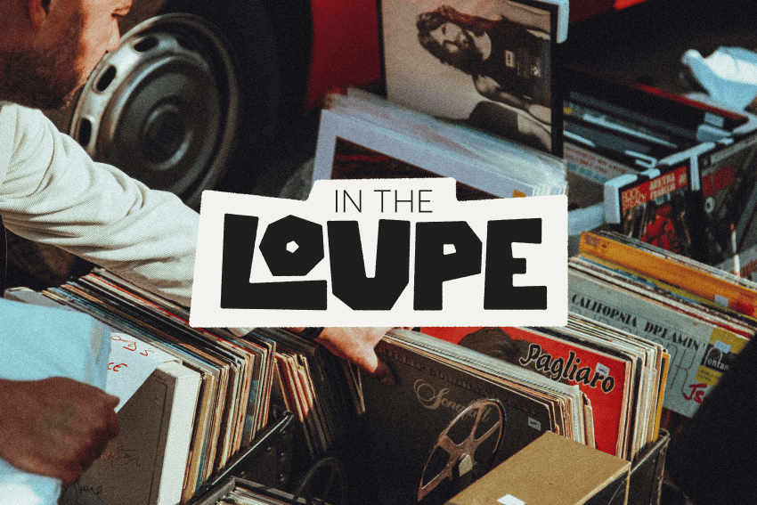Une personne feuilletant des vinyles dans des caisses avec le texte 'In The Loupe' au centre.