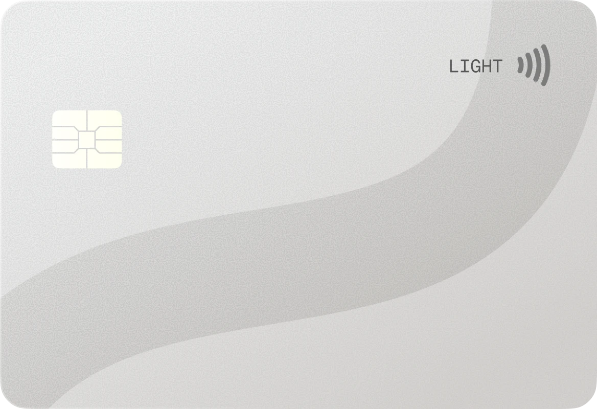 Minimalist light gray credit card with chip and contactless payment symbol.