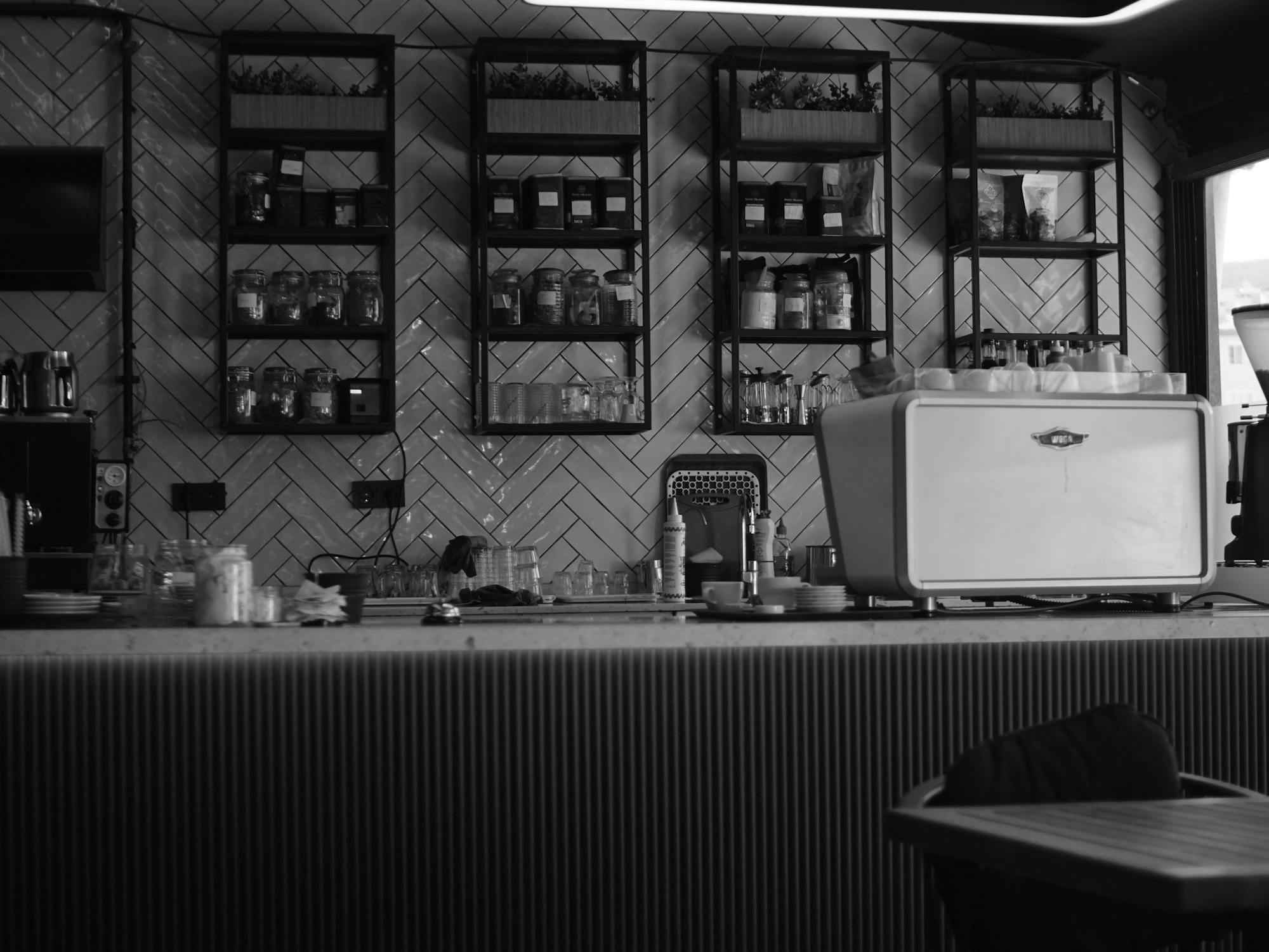 Black and white stylised urban cafe interior with coffee equipment