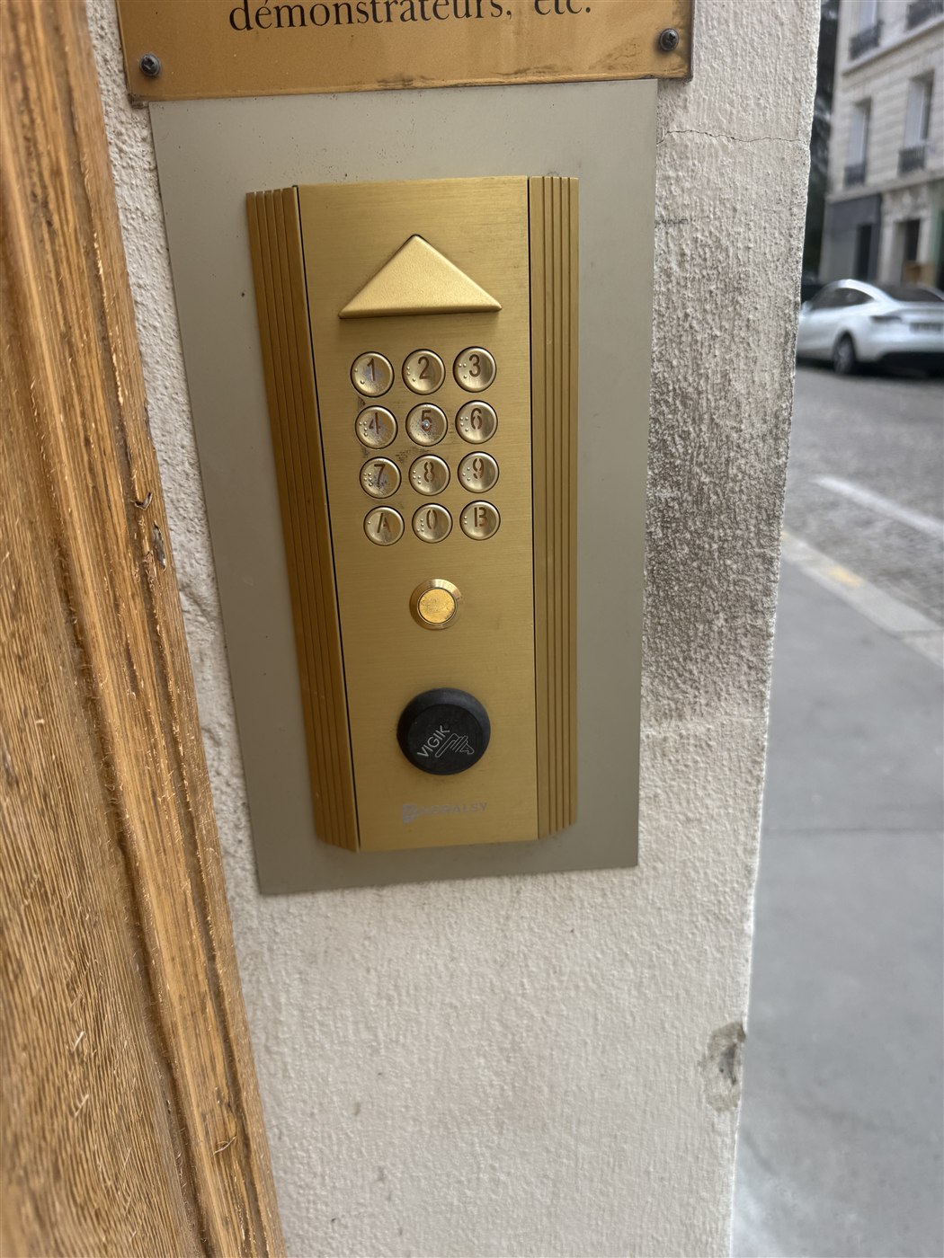 Clavier codé Noralsy doré avec lecteur Vigik sur une façade parisienne