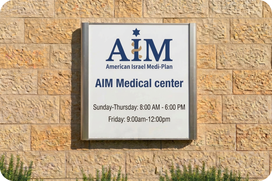 Sign on stone wall showing AIM Clinic office hours from Sunday to Saturday with varying times and closure on Saturday.