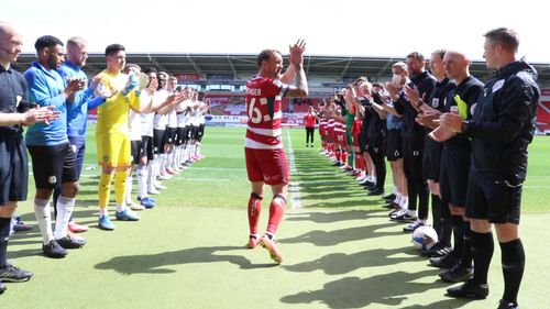 Footballer celebrating a title win