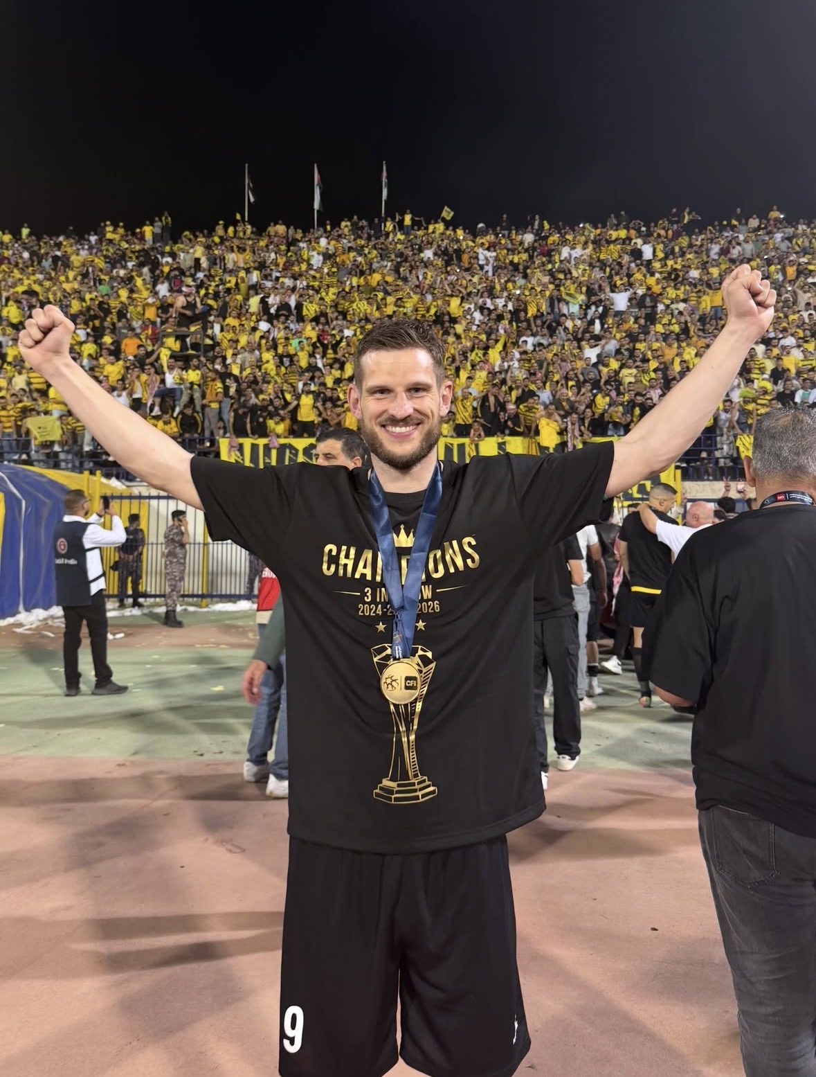 Footballer celebrating a title win