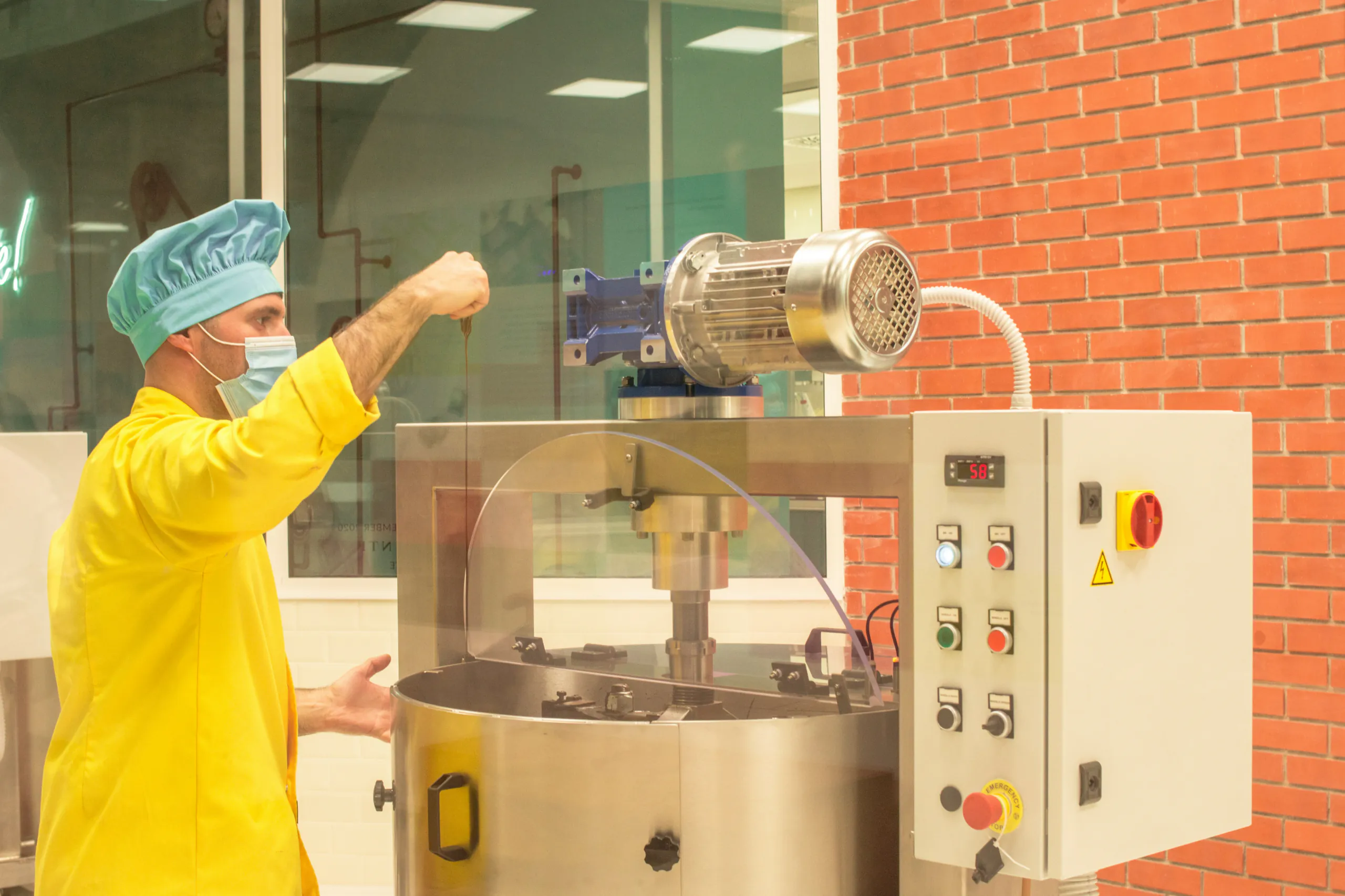 Chocolate being processed and tempered in a factory