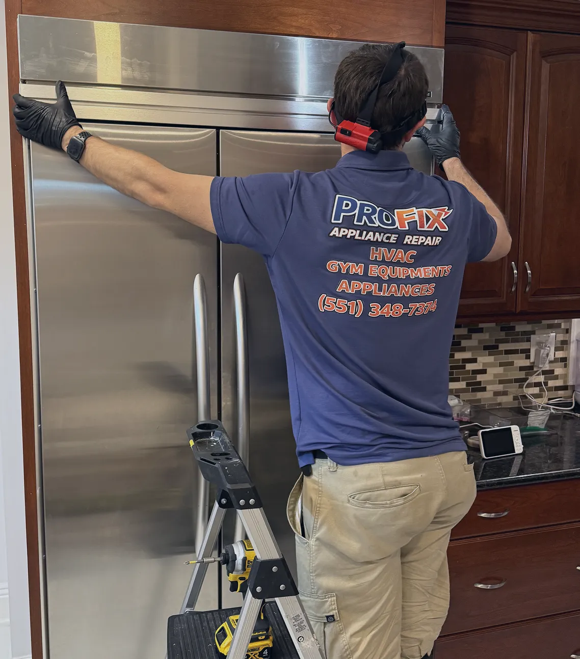 ProFix technician servicing a built-in refrigerator during a repair call in Bridgewater NJ