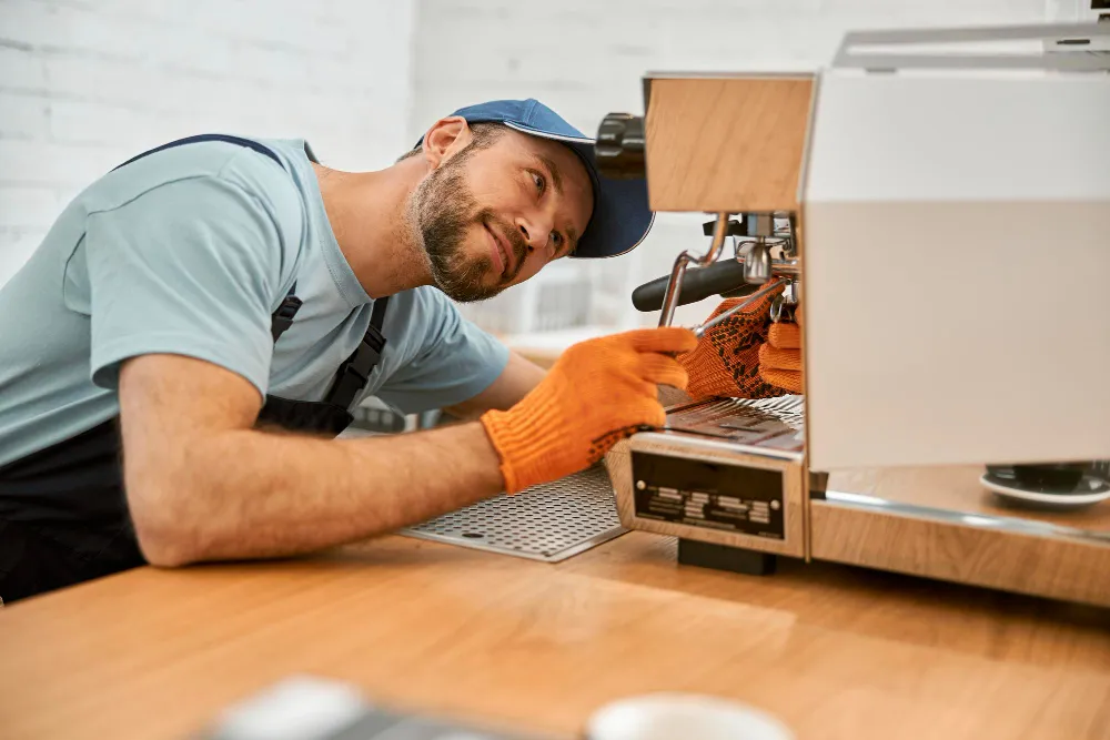 `Appliance repair technician servicing a coffee machine`