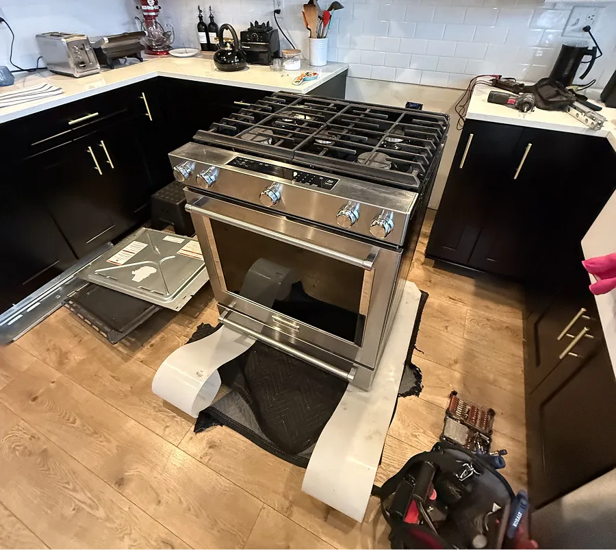 Gas range pulled out from cabinets during a stove repair service call in NJ