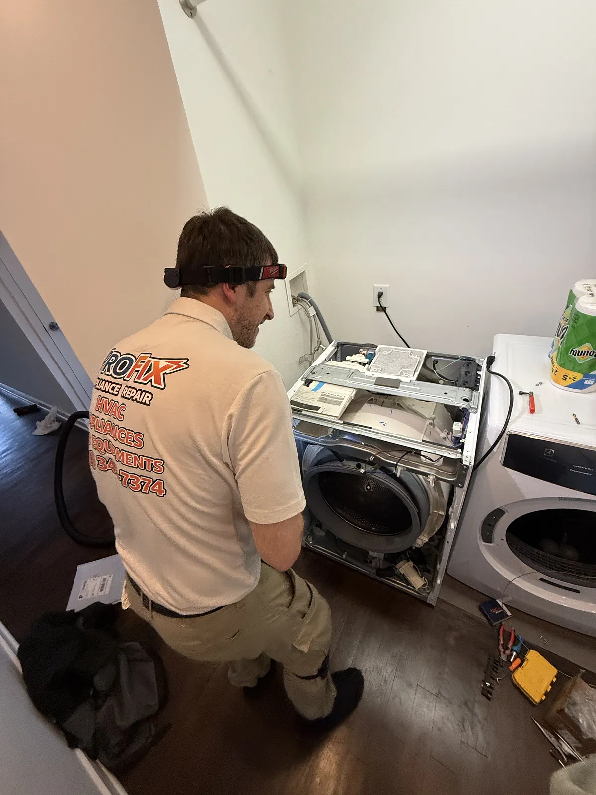 ProFix technician disassembling a front-load dryer during a dryer repair service call in Bridgewater NJ