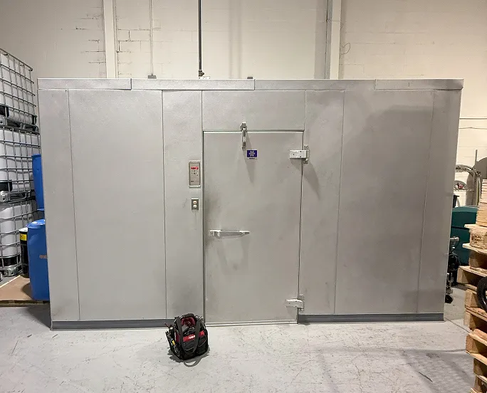 Commercial walk-in refrigerator exterior with insulated panels and heavy-duty door 