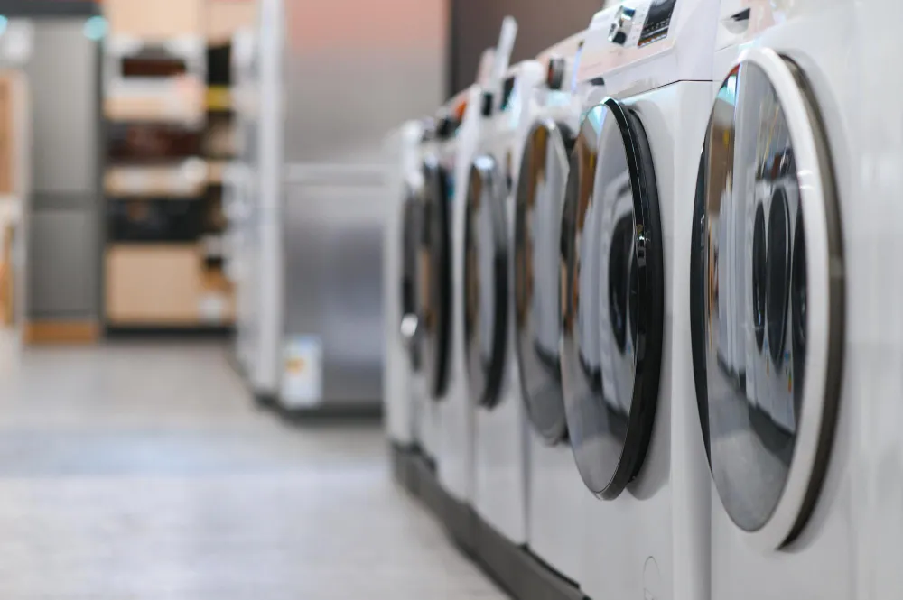 Row of front-load washing machines in a laundromat