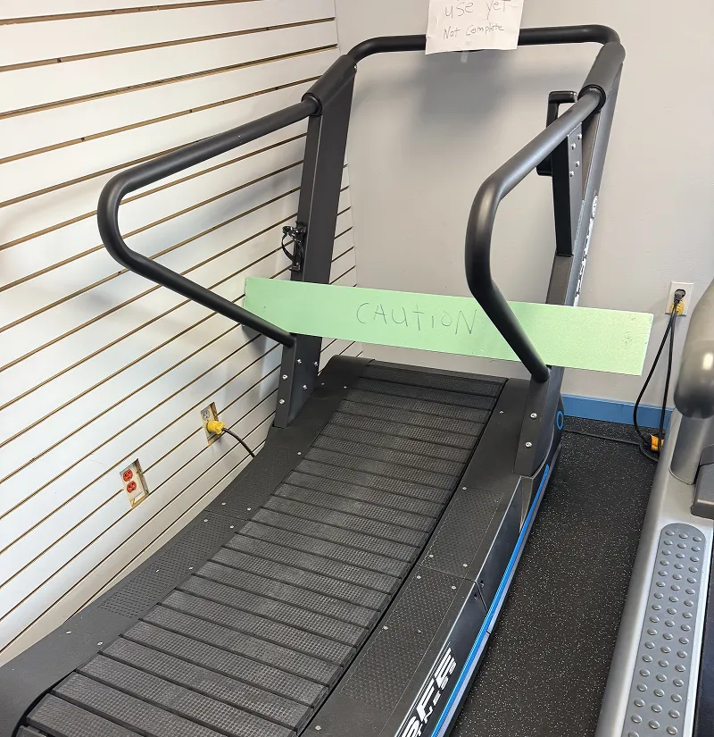 Commercial treadmill with caution sign