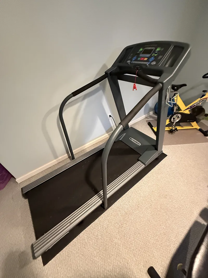 A gray treadmill with a digital display 