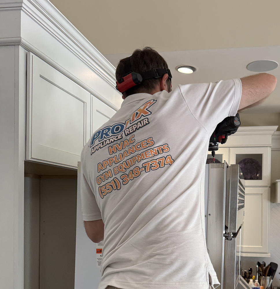 appliance technician repairing refrigerator