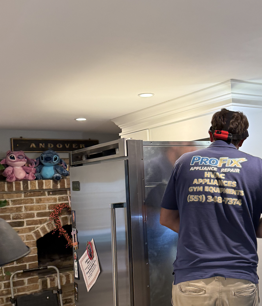 ProFix technician inspecting a stainless steel refrigerator during a service call at a residential home in New Jersey